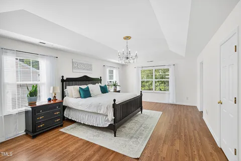 a bedroom with a bed and cabinet