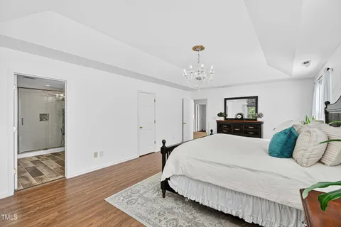 a spacious bedroom with a bed and a window