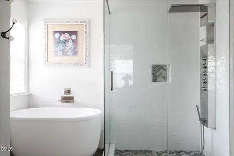 a bathroom with a sink a mirror and a shower