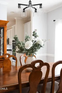 a dining room with furniture and a chandelier
