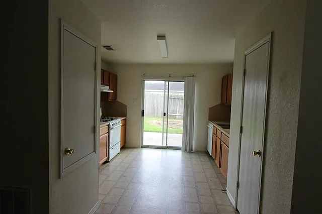 a kitchen with a refrigerator and a sink