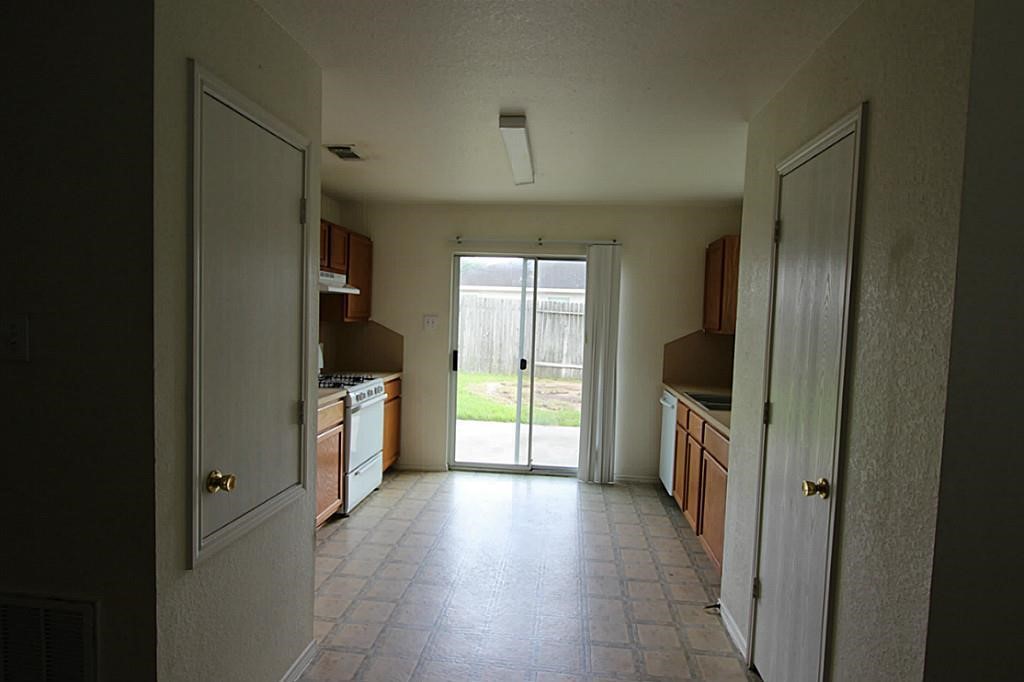 5015 Fox Mill Lane Spring, TX 77389 - Photo 7 of 9 a kitchen with a refrigerator and a sink
