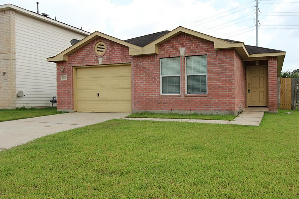 5015 Fox Mill Lane Spring, TX 77389 - Photo 9 of 9 a front view of a house with a yard and garage