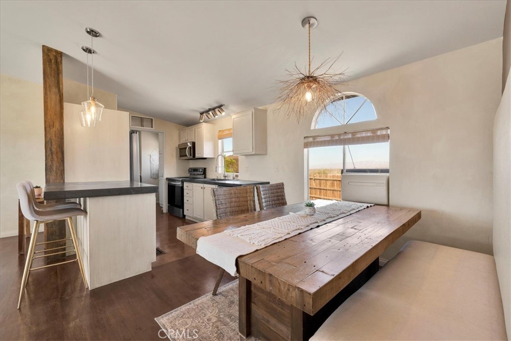 60707 Sonora Road Joshua Tree, CA 92252 - Photo 20 of 48 a living room with stainless steel appliances granite countertop furniture and a dining table with kitchen view