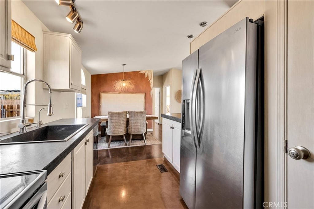 60707 Sonora Road Joshua Tree, CA 92252 - Photo 24 of 48 a kitchen with stainless steel appliances granite countertop a refrigerator and a sink