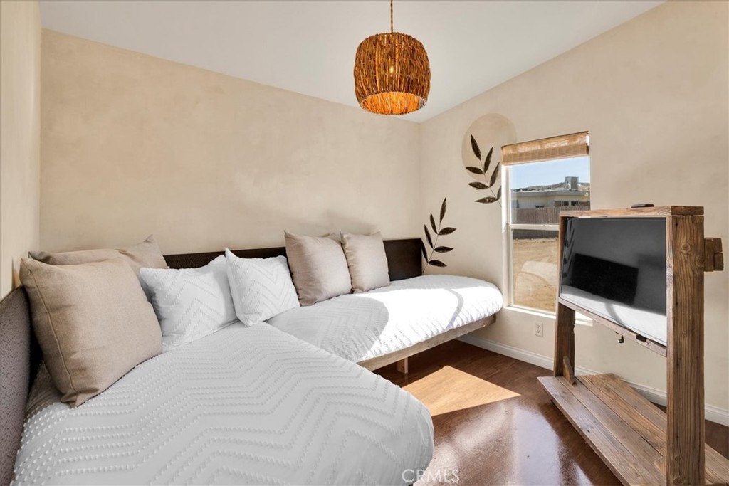 60707 Sonora Road Joshua Tree, CA 92252 - Photo 36 of 48 a living room with furniture and a flat screen tv