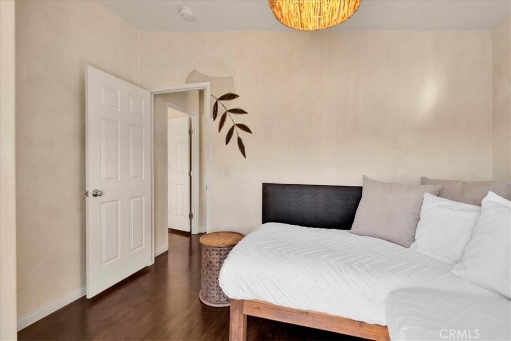 60707 Sonora Road Joshua Tree, CA 92252 - Photo 37 of 48 a bedroom with a bed and wooden floor