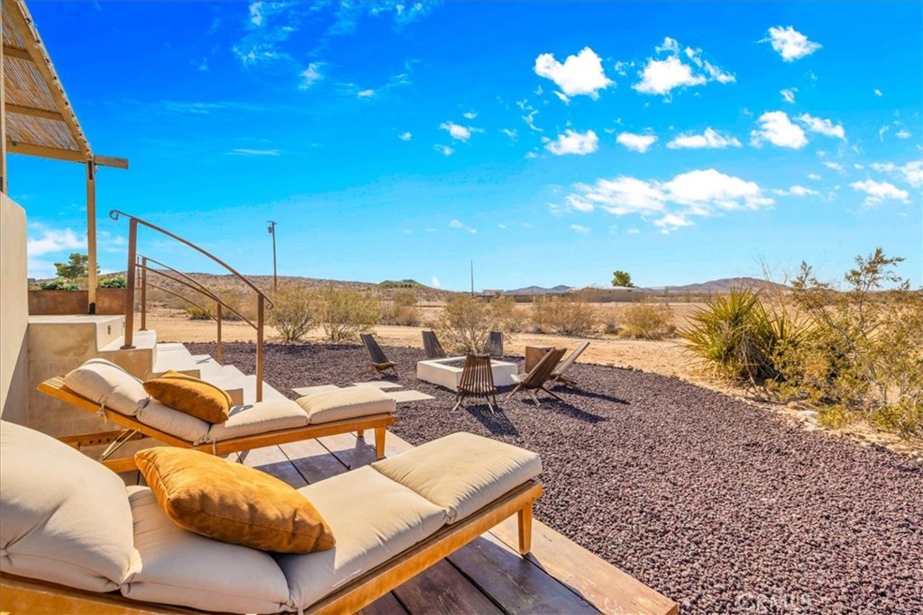 60707 Sonora Road Joshua Tree, CA 92252 - Photo 5 of 48 a view of a terrace with furniture and a yard