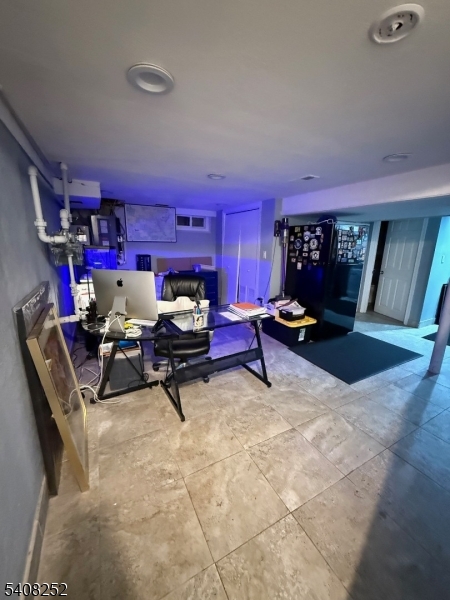 71 Wingra Avenue Rutherford, NJ 07070 - Photo 15 of 20 a living room with furniture gym equipment and a fireplace