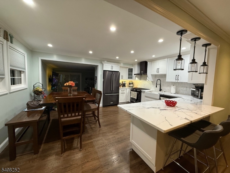 71 Wingra Avenue Rutherford, NJ 07070 - Photo 4 of 20 a kitchen with stainless steel appliances kitchen island granite countertop a table chairs and a refrigerator