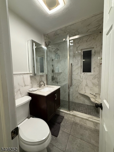 71 Wingra Avenue Rutherford, NJ 07070 - Photo 6 of 20 a bathroom with a sink toilet a mirror and shower