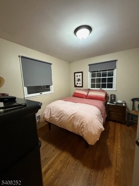 71 Wingra Avenue Rutherford, NJ 07070 - Photo 8 of 20 a bedroom with a bed and a flat screen tv