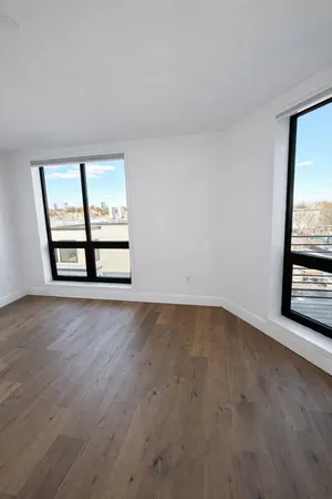 an empty room with windows and entrance