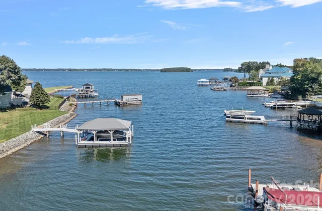a aerial view of a house with outdoor space lake view and mountain view