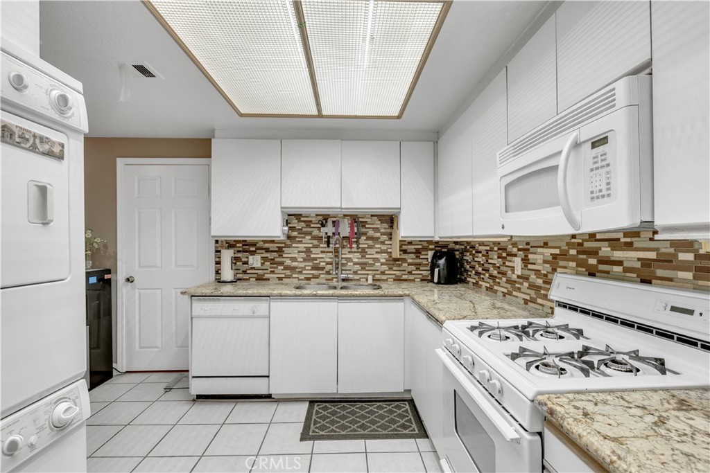 10511 Ashton Avenue, Unit 101 Los Angeles, CA 90024 - Photo 14 of 30 stackable laundry in kitchen