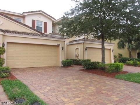 4063 Cherrybrook Loop Fort Myers, FL 33966 - Photo 3 of 15 a front view of a house with a yard and garage