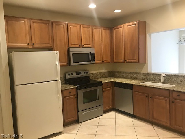 4063 Cherrybrook Loop Fort Myers, FL 33966 - Photo 4 of 15 a kitchen with appliances a sink and cabinets