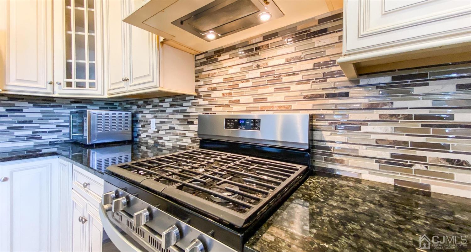 21 Hillsdale Road Edison, NJ 08820 - Photo 8 of 24 a kitchen with stove and cabinets