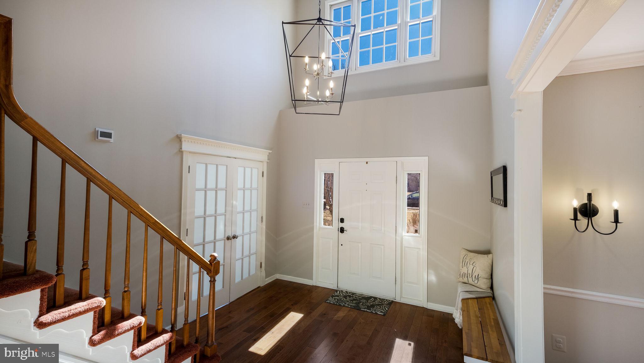 4 Bittersweet Drive Doylestown, PA 18901 - Photo 2 of 32 a view of a hallway with wooden floor and staircase
