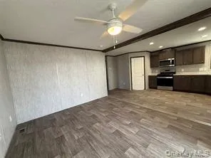 a view of a kitchen with a sink and a refrigerator