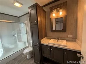 a bathroom with a sink a toilet and shower