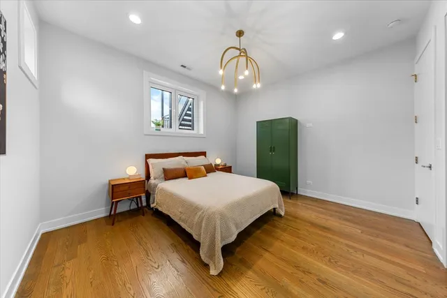 a bedroom with a bed and a wooden floor