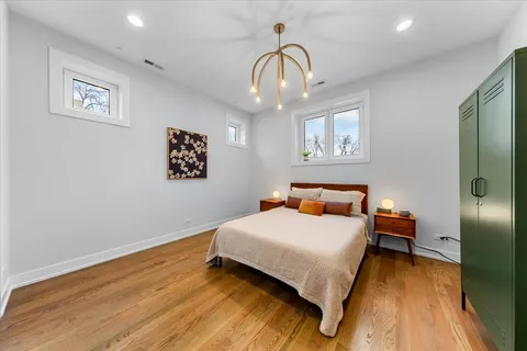 a bedroom with a bed and a chandelier