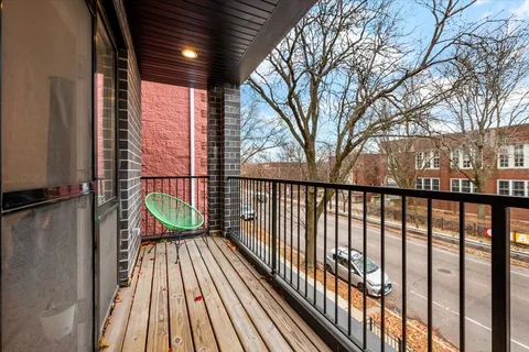a view of balcony with wooden floor and fence