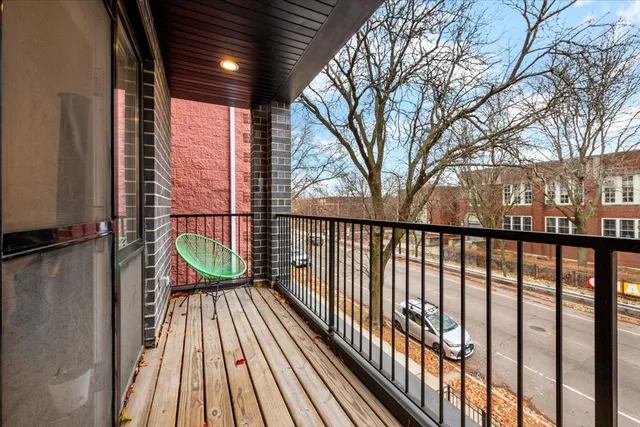 a view of balcony with wooden floor and fence