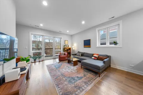 a living room with furniture large window and a table