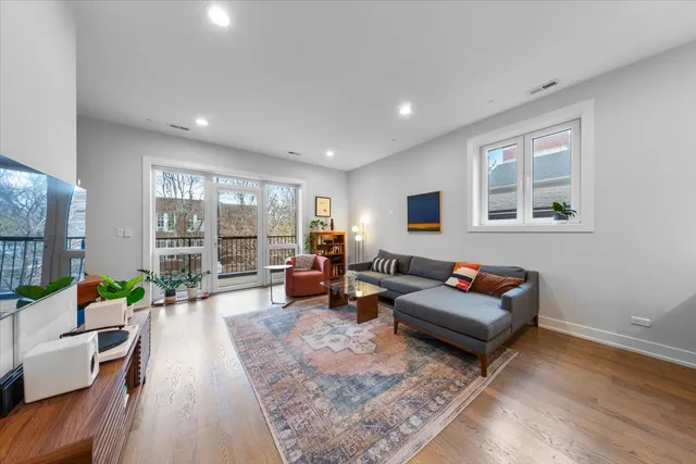 a living room with furniture large window and a table