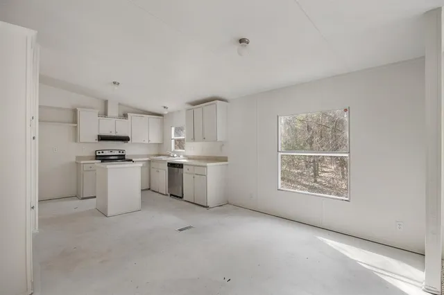 a kitchen with white cabinets and white appliances