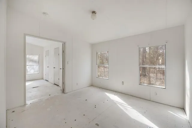an empty room with windows and closet