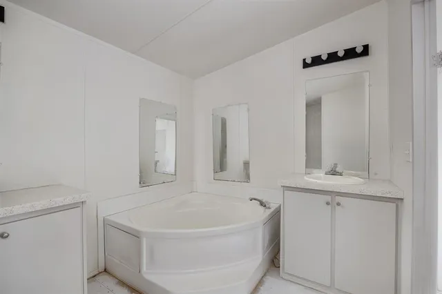 a bathroom with a bathtub and a sink
