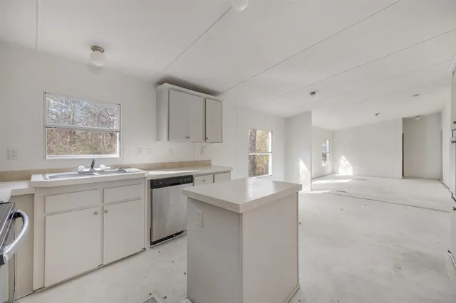 a kitchen with a sink cabinets and window