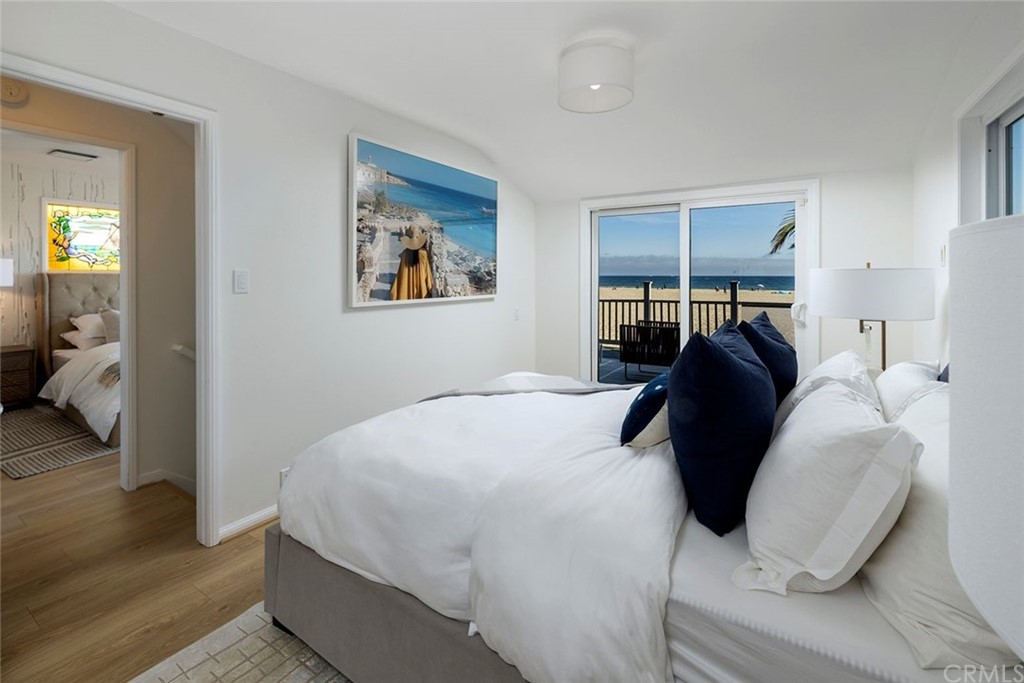 1708 West Oceanfront Newport Beach, CA 92663 - Photo 15 of 43 a bedroom with a bed and wooden floor