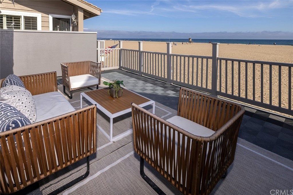 1708 West Oceanfront Newport Beach, CA 92663 - Photo 18 of 43 a balcony with table and chairs