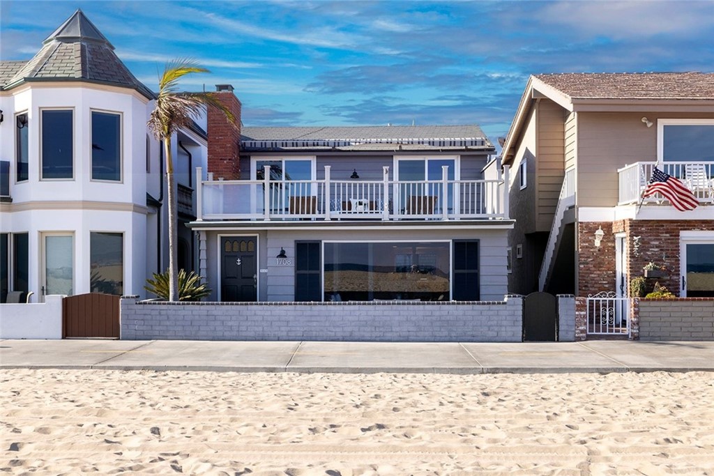 1708 West Oceanfront Newport Beach, CA 92663 - Photo 23 of 43 a front view of a house with a yard