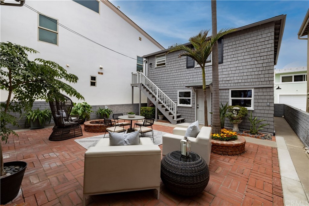 1708 West Oceanfront Newport Beach, CA 92663 - Photo 27 of 43 a view of a patio with couches and potted plants