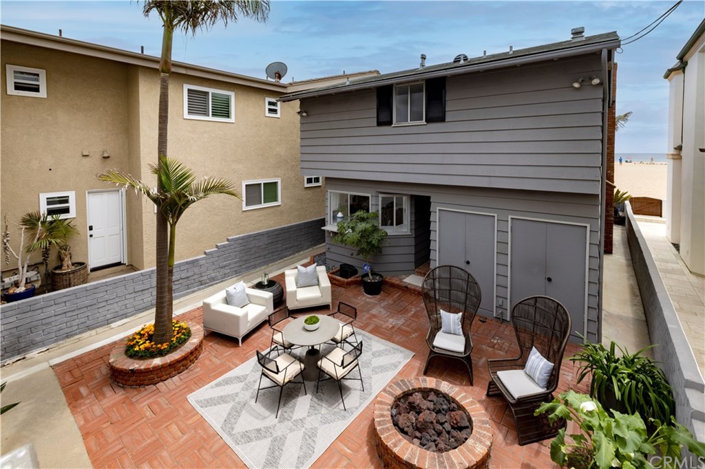 1708 West Oceanfront Newport Beach, CA 92663 - Photo 28 of 43 a table and chairs in front of a house