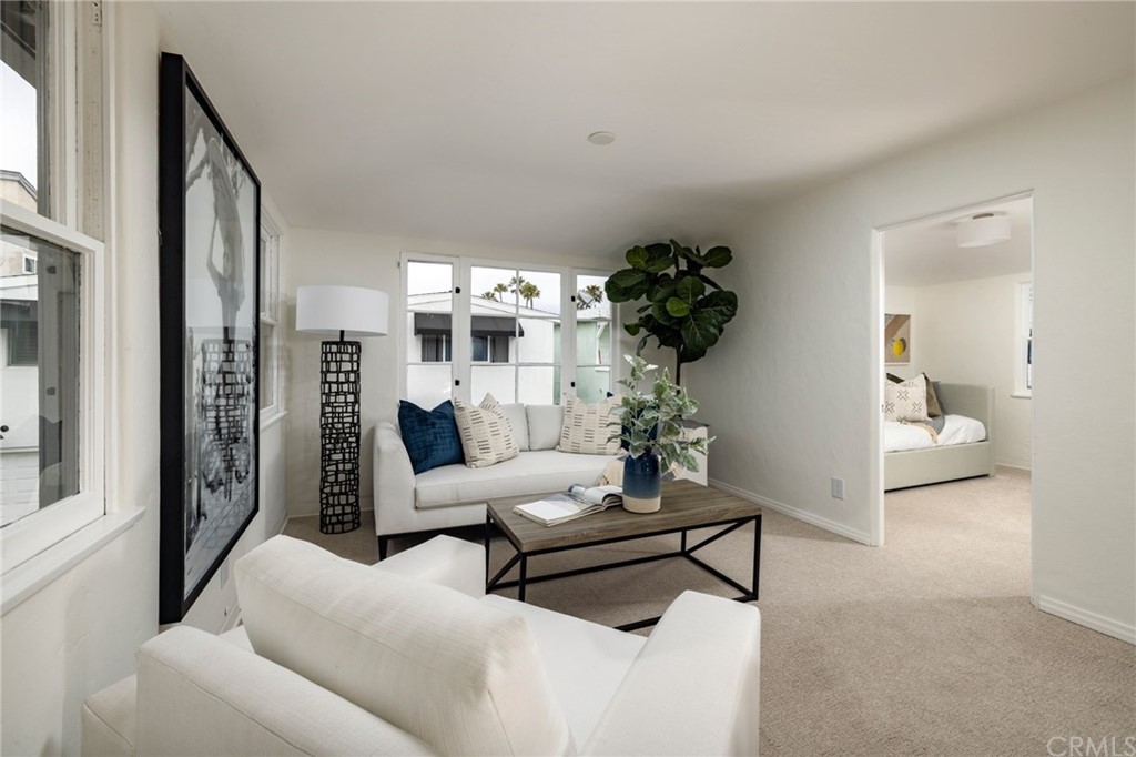 1708 West Oceanfront Newport Beach, CA 92663 - Photo 30 of 43 a living room with furniture and a potted plant