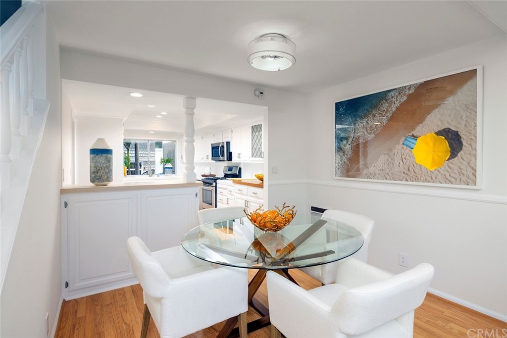 1708 West Oceanfront Newport Beach, CA 92663 - Photo 3 of 43 a dining room with furniture and wooden floor