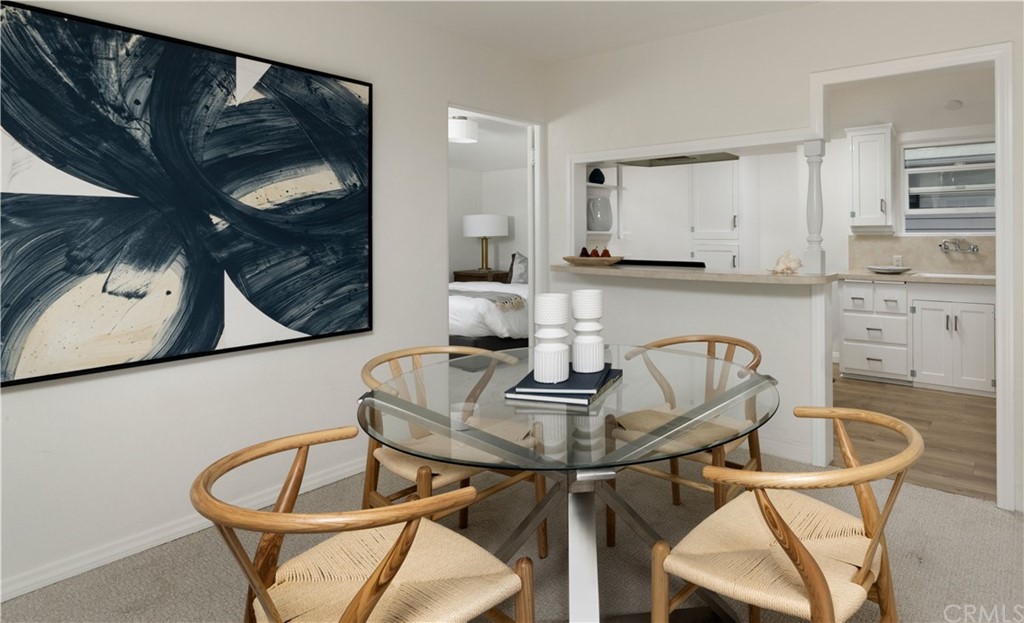 1708 West Oceanfront Newport Beach, CA 92663 - Photo 31 of 43 a kitchen with a table chairs and cabinets