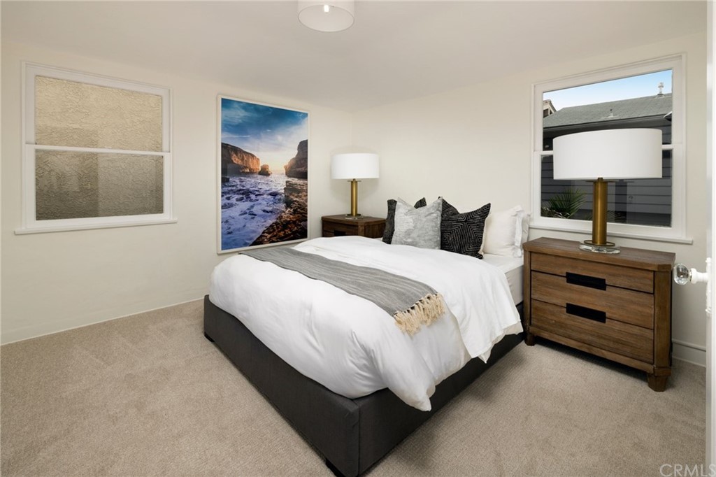 1708 West Oceanfront Newport Beach, CA 92663 - Photo 33 of 43 a bedroom with a bed and a flat tv screen on dresser