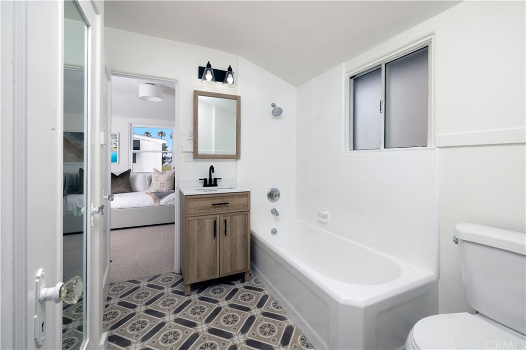 1708 West Oceanfront Newport Beach, CA 92663 - Photo 35 of 43 a bathroom with a sink toilet and shower