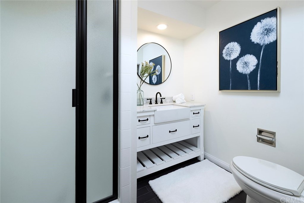 1708 West Oceanfront Newport Beach, CA 92663 - Photo 9 of 43 a bathroom with a toilet a sink and mirror