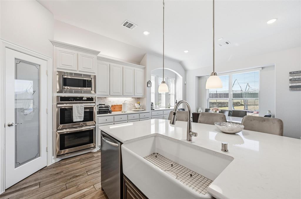 609 Dusty Glen Trail Midlothian, TX 76065 - Photo 11 of 40 a kitchen with a sink a counter top stainless steel appliances and cabinets