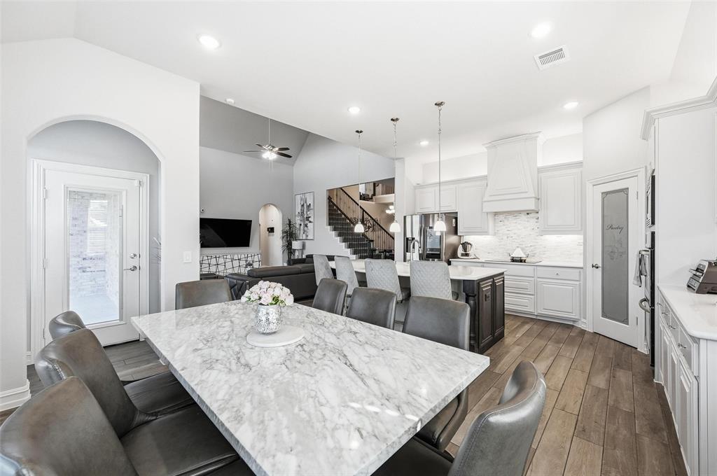 609 Dusty Glen Trail Midlothian, TX 76065 - Photo 13 of 40 a large kitchen with kitchen island a stove a sink a refrigerator and a dining table