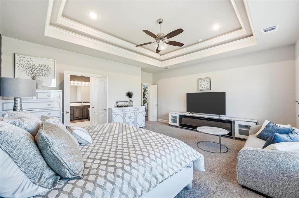 609 Dusty Glen Trail Midlothian, TX 76065 - Photo 17 of 40 a bedroom with a bed and a flat screen tv