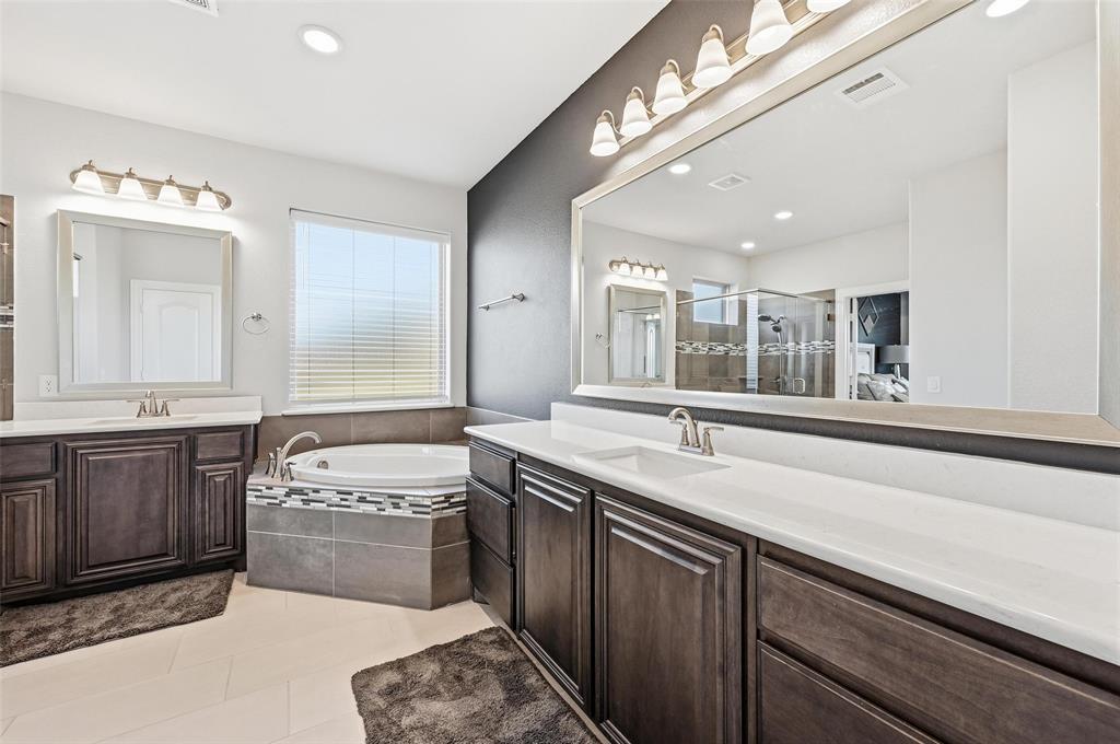 609 Dusty Glen Trail Midlothian, TX 76065 - Photo 20 of 40 a spacious bathroom with a sink a large mirror and a bathtub